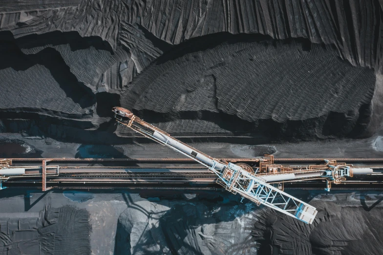 a large crane sitting on top of a pile of coal, a portrait, pexels contest winner, color aerial photo drone, conveyor belts, deep black, thumbnail