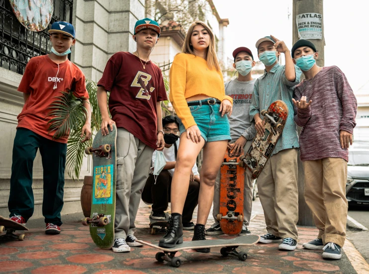 a group of people standing next to each other with skateboards, an album cover, by Gina Pellón, pexels contest winner, people are wearing masks, manila, teenage girl, performing a music video