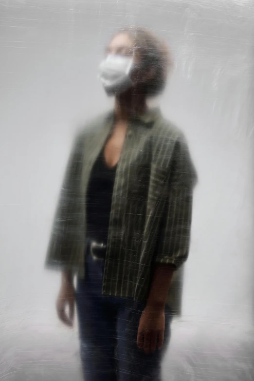 a blurry photo of a woman wearing a face mask, by Caro Niederer, cropped shirt with jacket, ( conceptual art ), imane anys, 62 x 47 inches