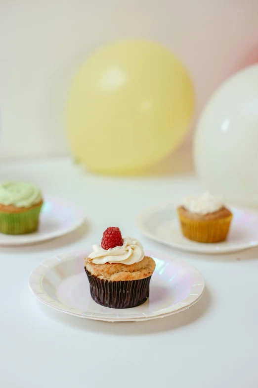 a number of cupcakes on plates on a table, by Nicolette Macnamara, renaissance, 3 - piece, balloon, vanilla, subtle color variations