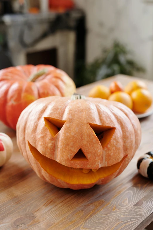 a carved pumpkin sitting on top of a wooden table, cheeks, medium - shot, ready to eat, face shown