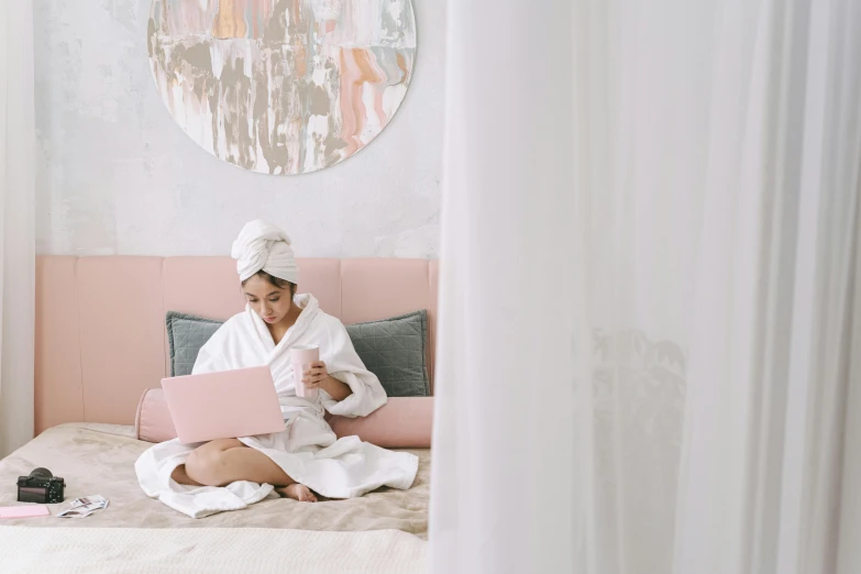 a woman sitting on a bed with a laptop, trending on pexels, happening, white and pink cloth, spa, white and gold robes, ilustration