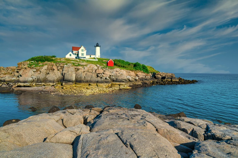 a lighthouse sitting on top of a rocky island, pexels contest winner, american impressionism, white buildings with red roofs, new hampshire, slide show, a colorful