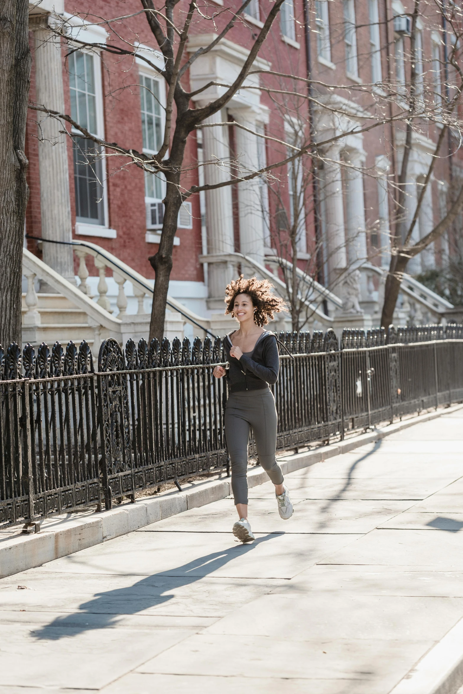 a woman running down a sidewalk on a sunny day, by Nina Hamnett, happening, curly haired, ignant, broadway, profile image