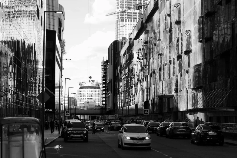 a black and white photo of a city street, a black and white photo, inspired by Thomas Struth, unsplash, brutalism, car traffic, canary wharf, colour splash, the sun is shining. photographic