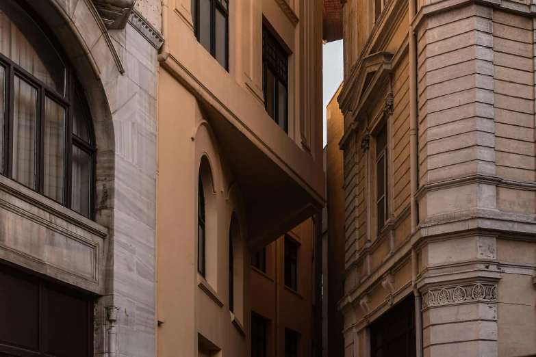 a couple of buildings that are next to each other, an album cover, pexels contest winner, neoclassicism, narrow passage, brown, afternoon light, istanbul