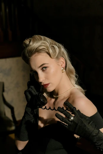 a woman in a black dress holding a phone to her ear, a portrait, trending on cg society, rococo, pretty margot robbie vampire, 1 9 5 0 s style, black gloves, shot with sony alpha 1 camera