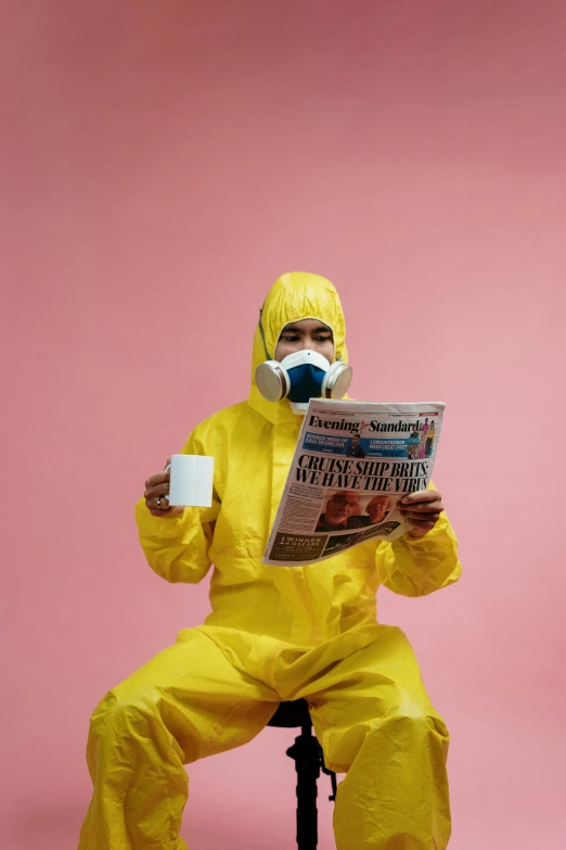 a man in a yellow hazmat suit reading a newspaper, a cartoon, pexels contest winner, wearing a light - pink suit, coronavirus, photoshoot, puke