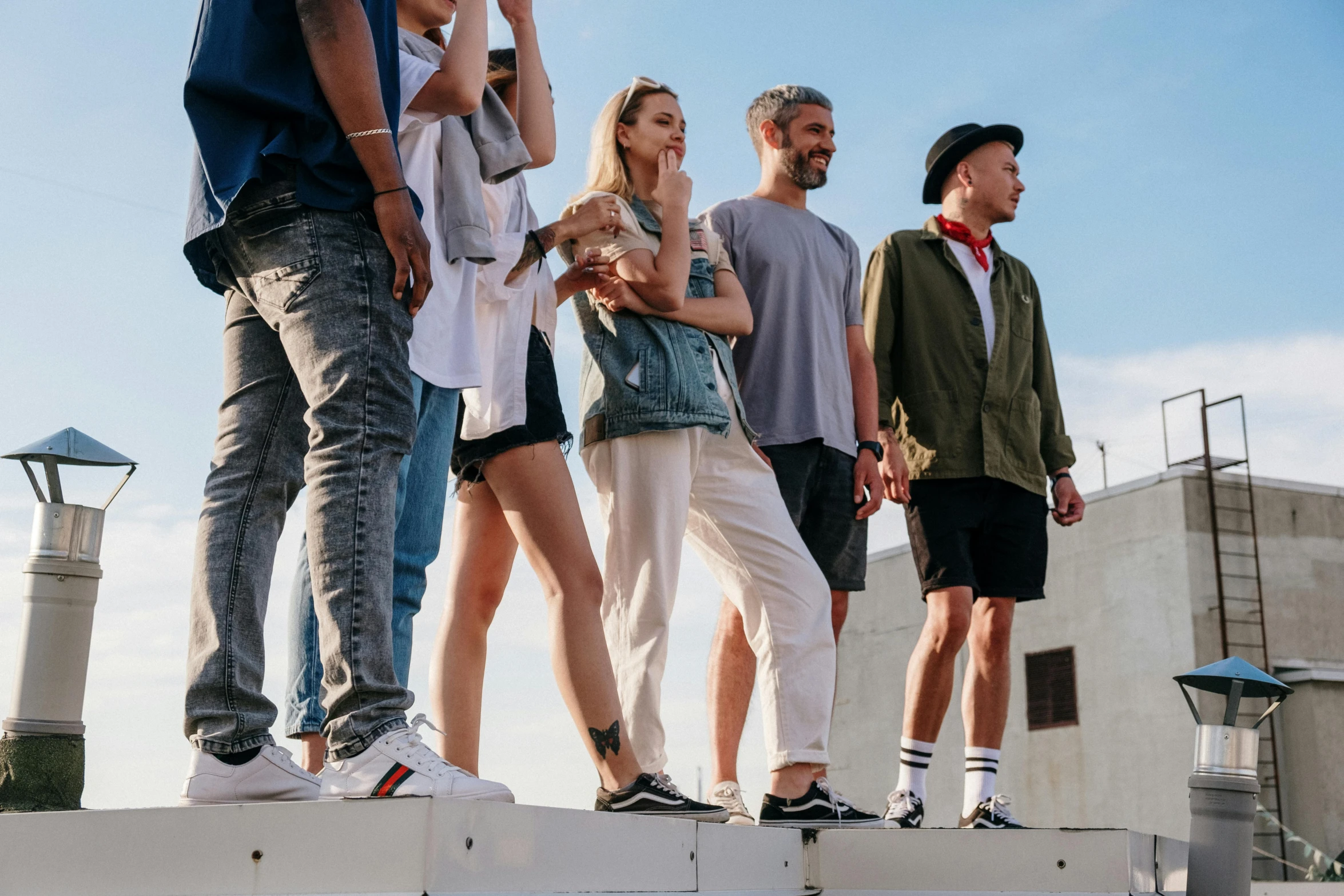 a group of people standing on top of a building, pexels contest winner, wearing casual clothing, catwalk, 15081959 21121991 01012000 4k, wears shorts