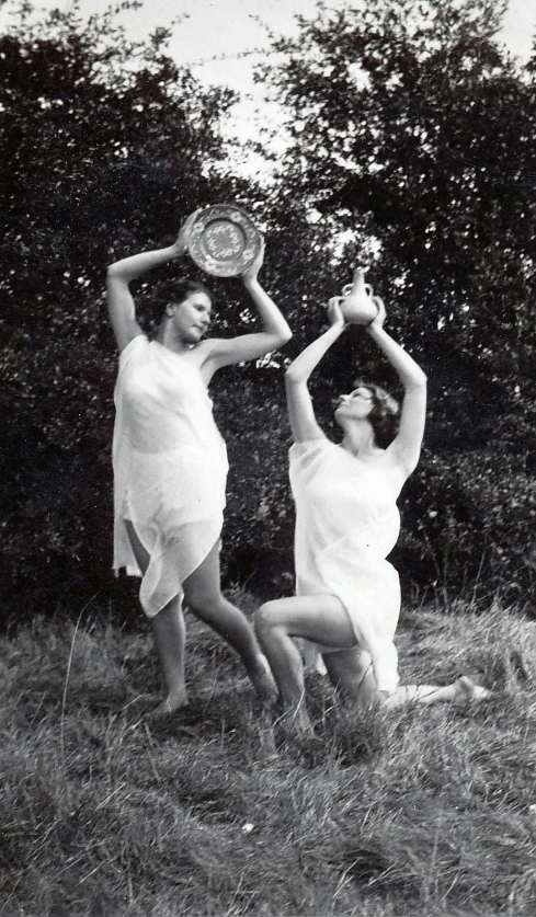 a black and white photo of two women holding tennis racquets, an album cover, by Gertrude Greene, symbolism, contemporary dance, overturned chalice, summer evening, photo 1998