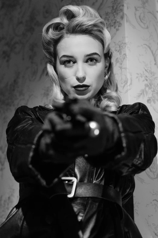 a black and white photo of a woman holding a gun, a black and white photo, inspired by Evaline Ness, reddit, black canary, black leahter gloves, sydney sweeney, rockabilly