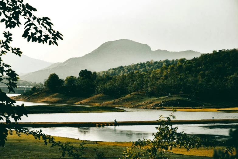 a large body of water surrounded by trees, by Jesper Knudsen, pexels contest winner, hurufiyya, guwahati, hills, festivals, 90s photo