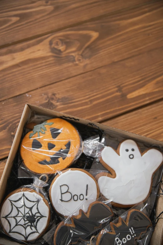 a box of decorated cookies on a wooden table, by Paul Bird, pexels, halloween scene, white, full product shot, thumbnail