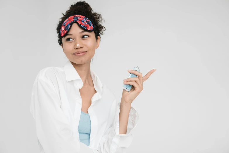 a woman in a white shirt holding a cell phone, skincare, bandana, h3h3, (doctor)