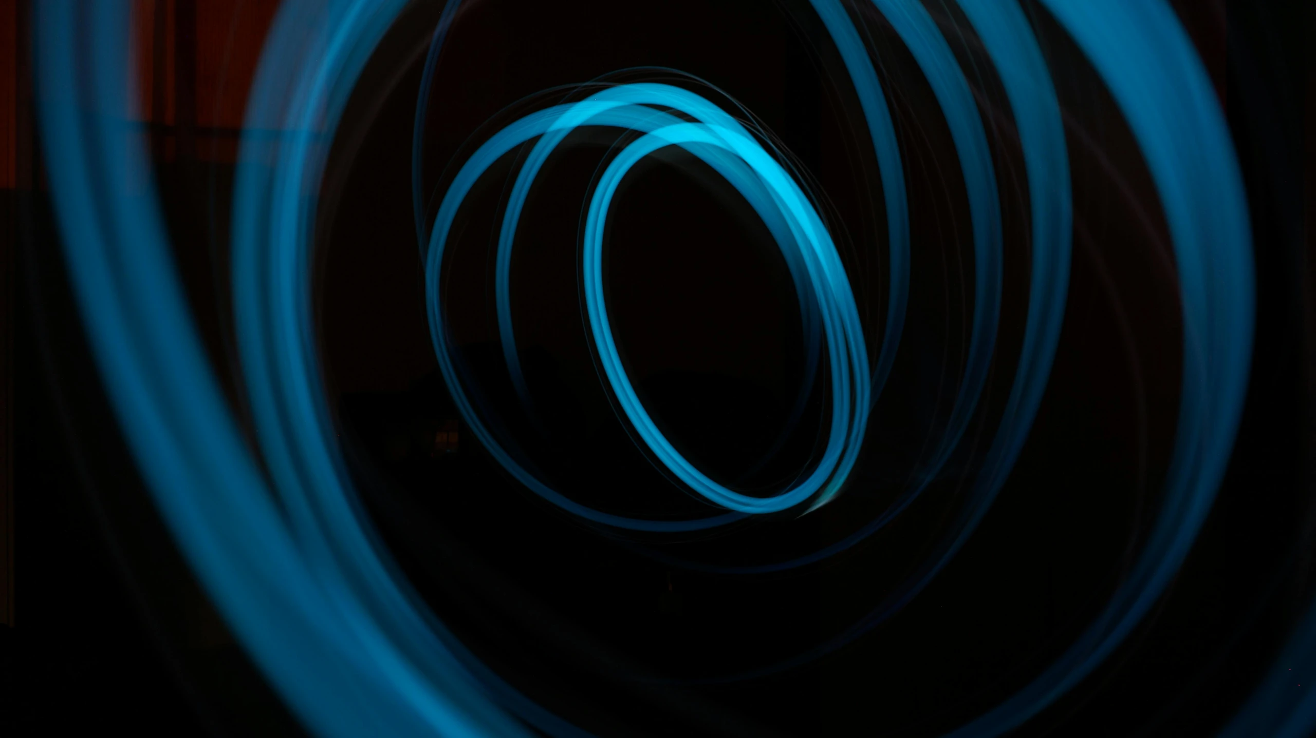 a close up of a blue light in a dark room, an album cover, swirly tubes, technological rings, ((blue)), light paint