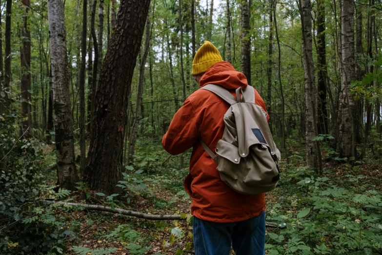 a man with a backpack walking through a forest, unsplash, visual art, still from a wes anderson film, eric cartman in real life, sustainable materials, ignant