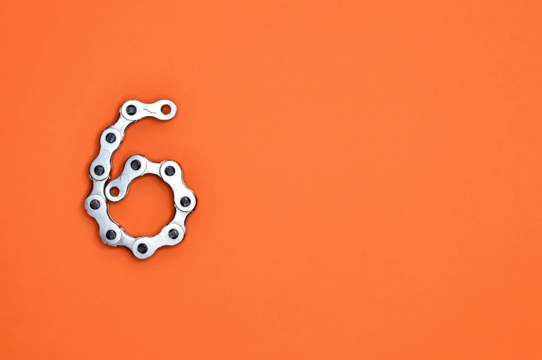 a bicycle chain on an orange background, trending on pexels, generative art, six arms, g6, hook as ring, numerical