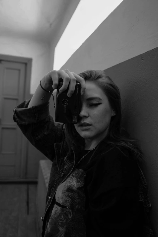 a woman taking a picture of herself in a mirror, a black and white photo, tumblr, florence pugh, ((portrait)), broken camera, medium format