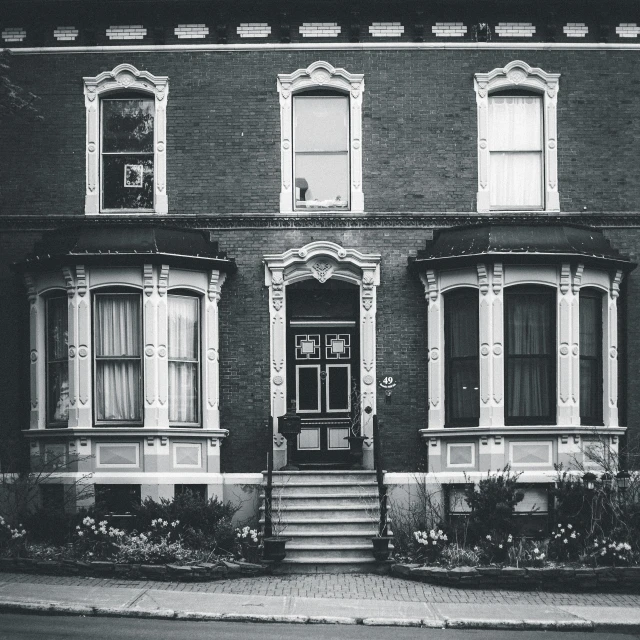 a black and white photo of a house, a black and white photo, pexels contest winner, art nouveau, montreal, 7 0 s photo, 3 doors, victorian england style