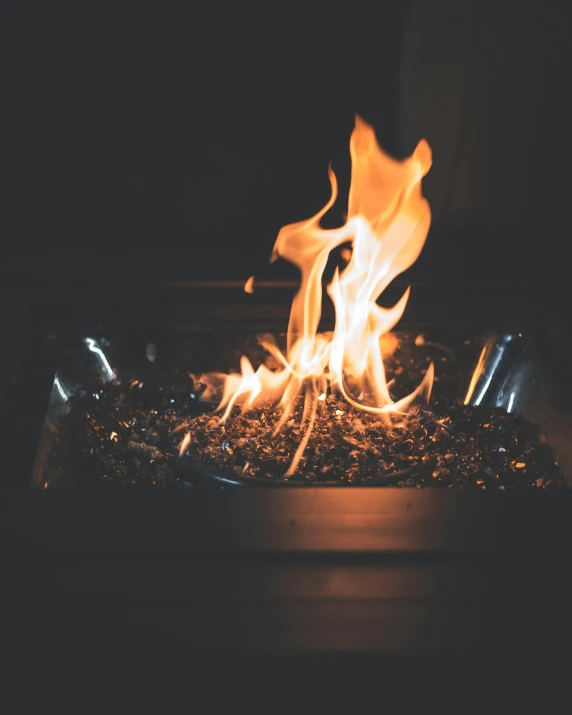 a fire pit sitting on top of a wooden table, profile image, flaming heart, dark. no text, sparkly