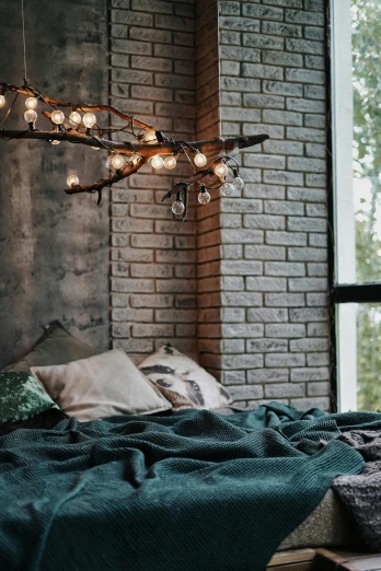 a bed sitting in a bedroom next to a window, inspired by Elsa Bleda, trending on pexels, light and space, christmas lights, branches, industrial lighting, soft green lighting