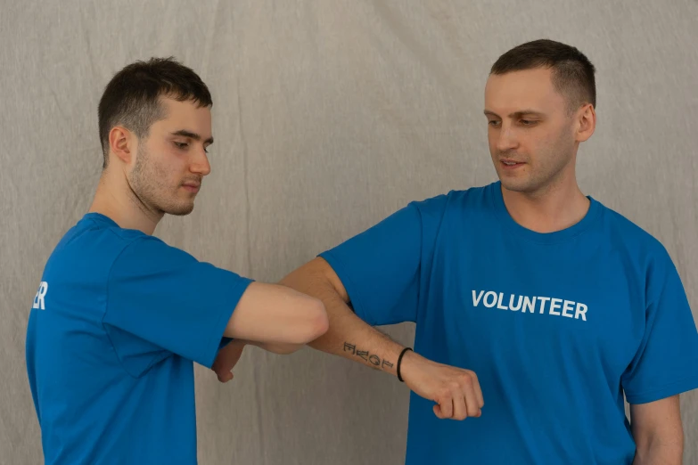 a couple of men standing next to each other, by Adam Marczyński, fist training, wearing a shirt, avatar image, bandage on arms