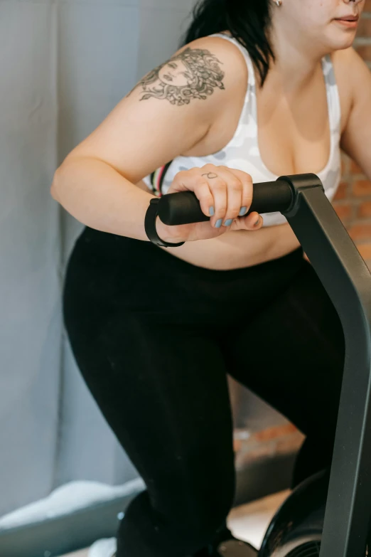 a woman riding a stationary bike in a gym, pexels contest winner, curvaceous. detailed expression, kailee mandel, profile image, inflatable