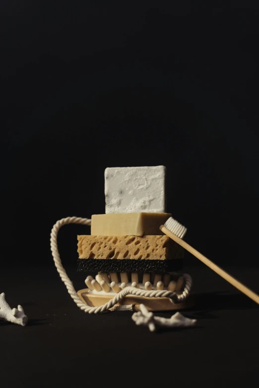 a soap dish sitting on top of a table next to a toothbrush, inspired by Frederik de Moucheron, conceptual art, marshmallow graham cracker, kris kuksi, ignant, stop motion animation