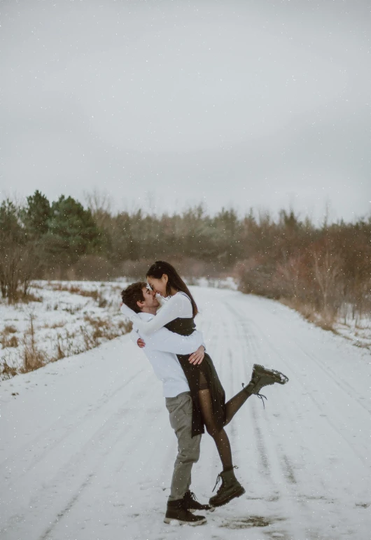 a man and woman kissing on a snowy road, colour photo, playful pose, taken in 2022, illustration »