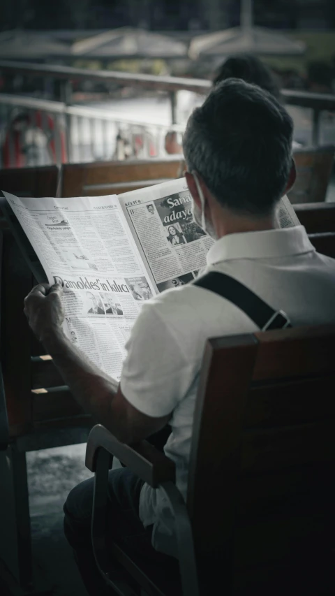 a man sitting on a bench reading a newspaper, a cartoon, pexels contest winner, private press, desaturated, reading in library, 15081959 21121991 01012000 4k, pictured from the shoulders up