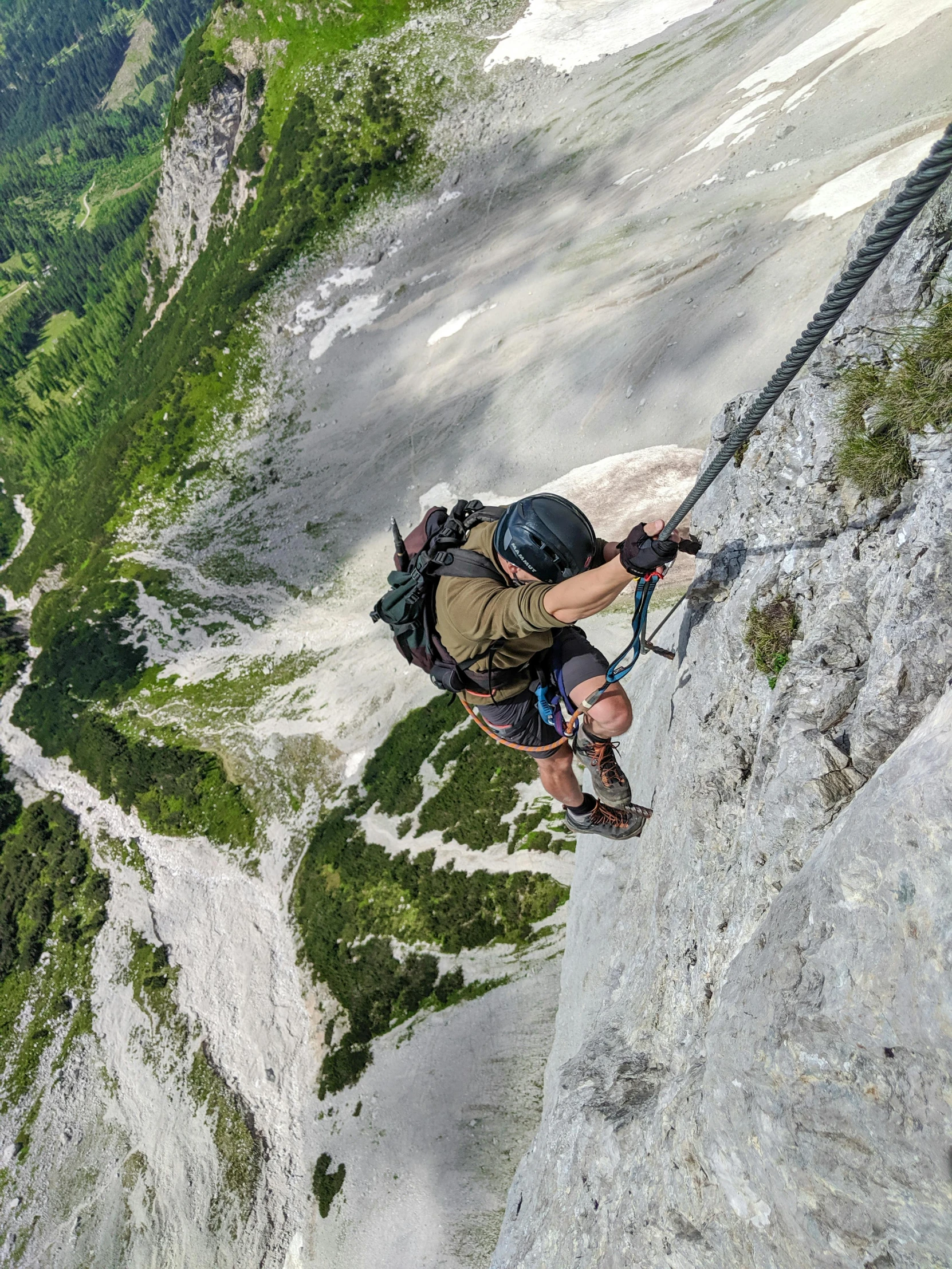 a man climbing up the side of a mountain, by Anna Haifisch, pexels contest winner, happening, hanging rope, high view, helmet off, avatar image