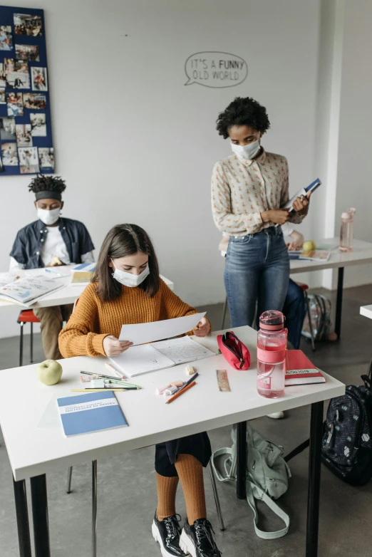 a group of people sitting at desks in a classroom, trending on pexels, academic art, people are wearing masks, children drawing with pencils, ayne haag, thumbnail