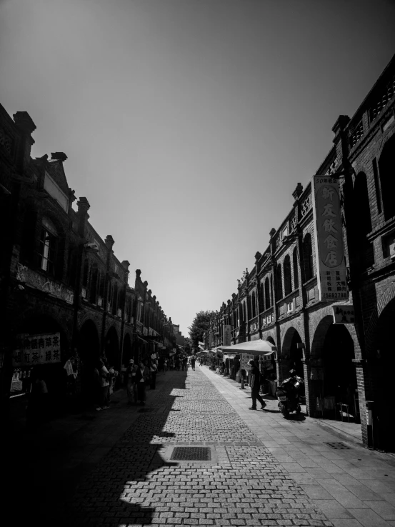 a black and white photo of a city street, by Fei Danxu, unsplash, mingei, in a sunny day, there are archways, square, cinematic. by leng jun