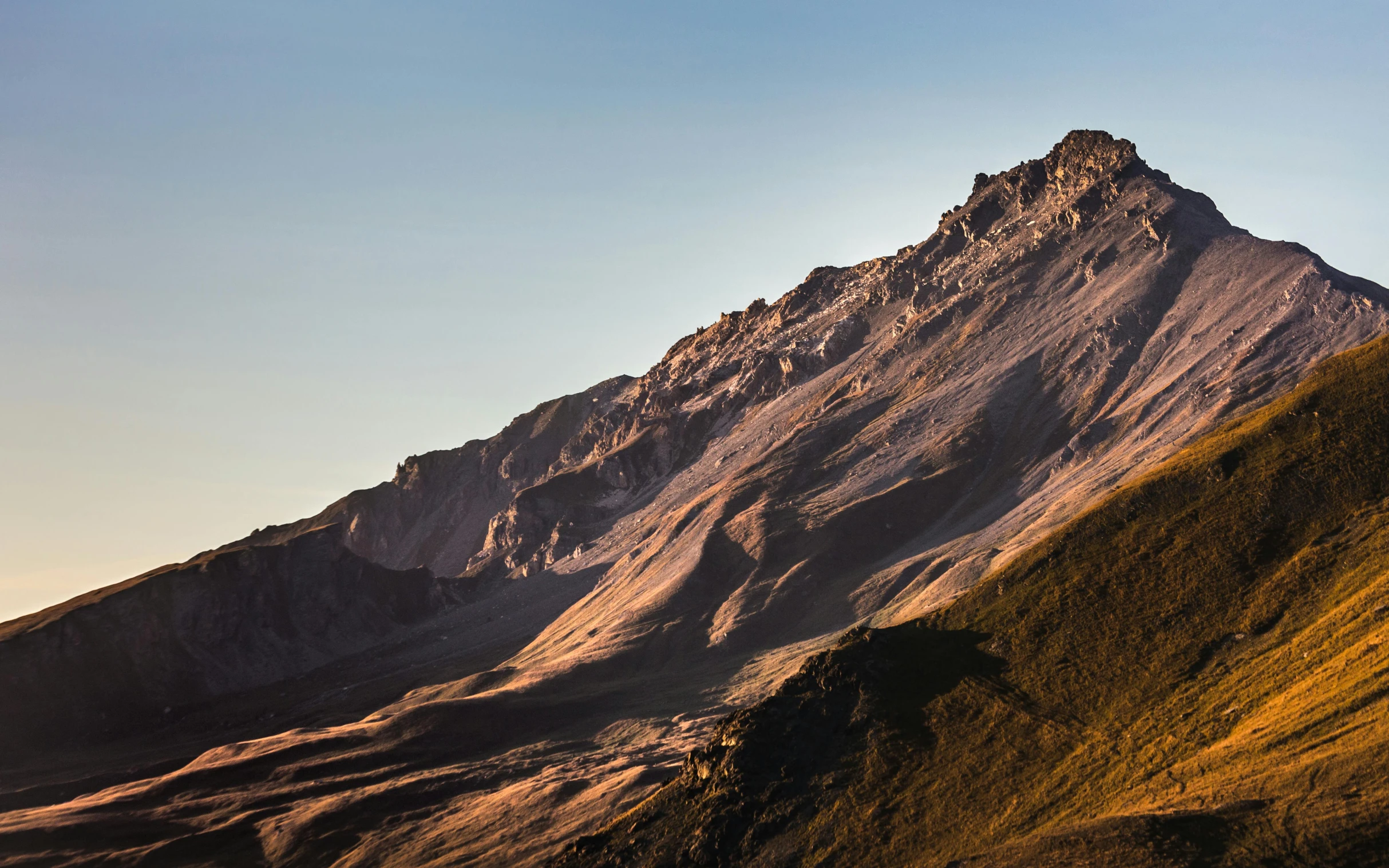 a group of people standing on top of a mountain, an album cover, by Peter Churcher, unsplash contest winner, sumatraism, dappled in evening light, chilean, geology, view from the side