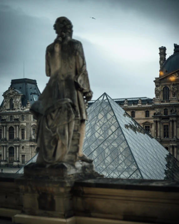 a statue of a woman with a glass pyramid in the background, by Julia Pishtar, pexels contest winner, french architecture, a photo of sephiroth, he got a big french musctache, looking out