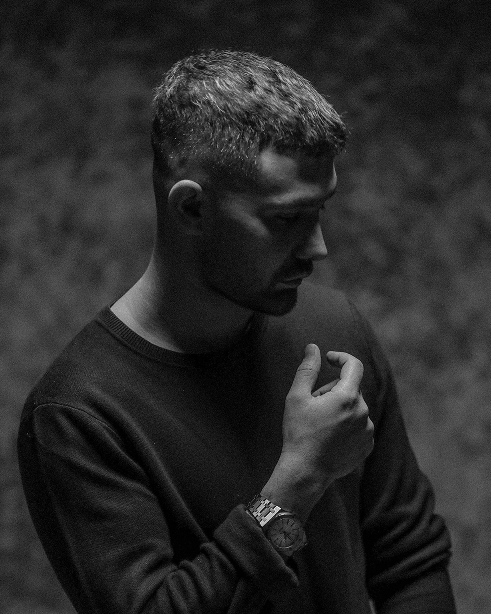 a black and white photo of a man wearing a watch, liam brazier and nielly, soft light from the side, cynthwave, indigo