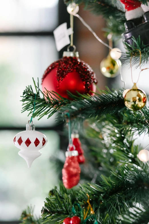 a close up of a christmas tree with ornaments, a portrait, inspired by Ernest William Christmas, pexels, crimson and white color scheme, multiple stories, indoor, traditional medium