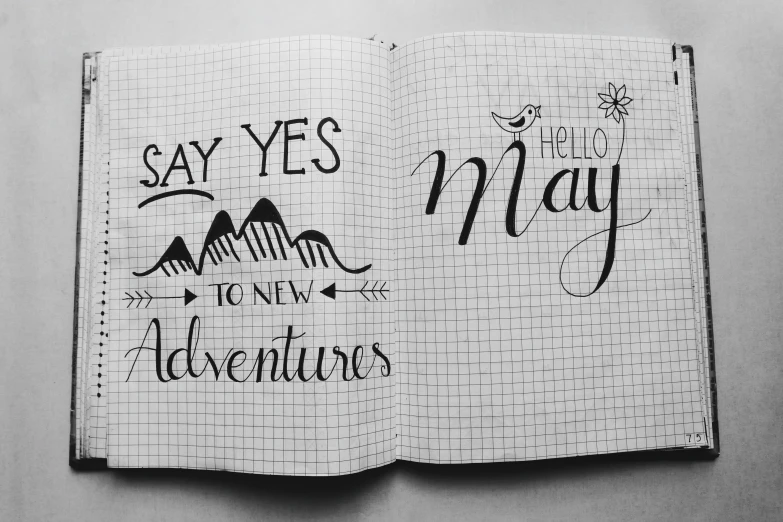 a notebook that has some writing on it, a black and white photo, by Caroline Mytinger, pexels contest winner, style lettering, new adventure, hey, may)