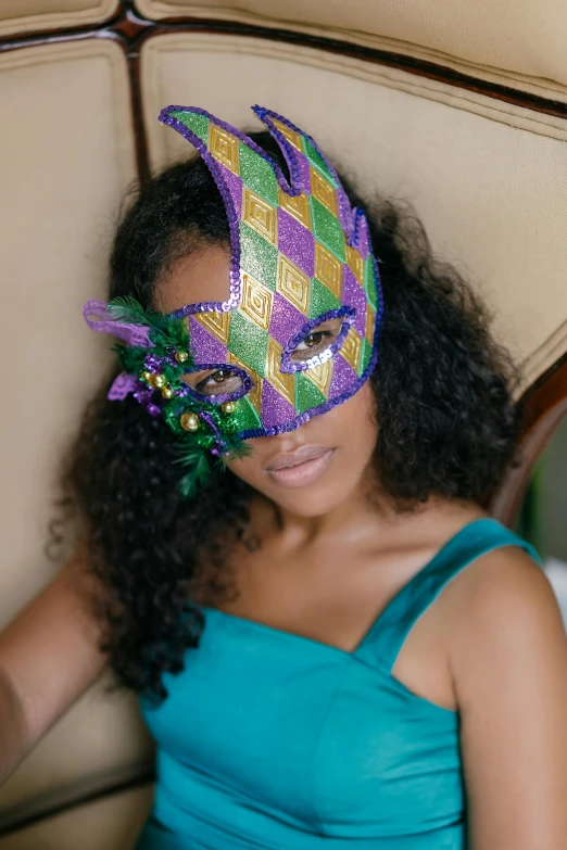 a woman sitting in a chair wearing a mask, trending on pexels, renaissance, gold green and purple colors”, louisiana, ashteroth, sequins