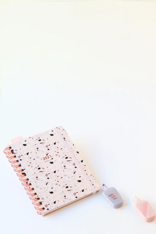 a pink notebook sitting on top of a white table, by Nicolette Macnamara, trending on unsplash, delicate patterned, toys, terrazzo, promo image