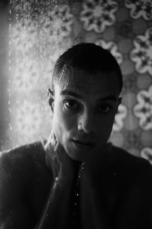 a black and white photo of a man in the shower, inspired by Antônio Parreiras, antipodeans, buzz cut hair, lucio as a woman, frank dillane, low quality photograph