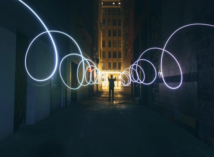 a person standing in the middle of a dark alley, interactive art, electrical arcs, instagram picture, focus shot, circles