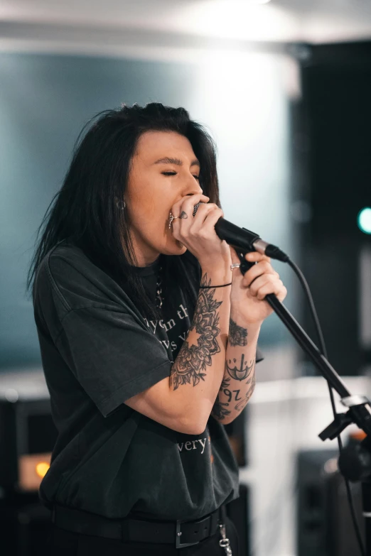 a woman singing into a microphone in a recording studio, a tattoo, trending on unsplash, antipodeans, stoner metal concert, half asian, profile image, julian ope