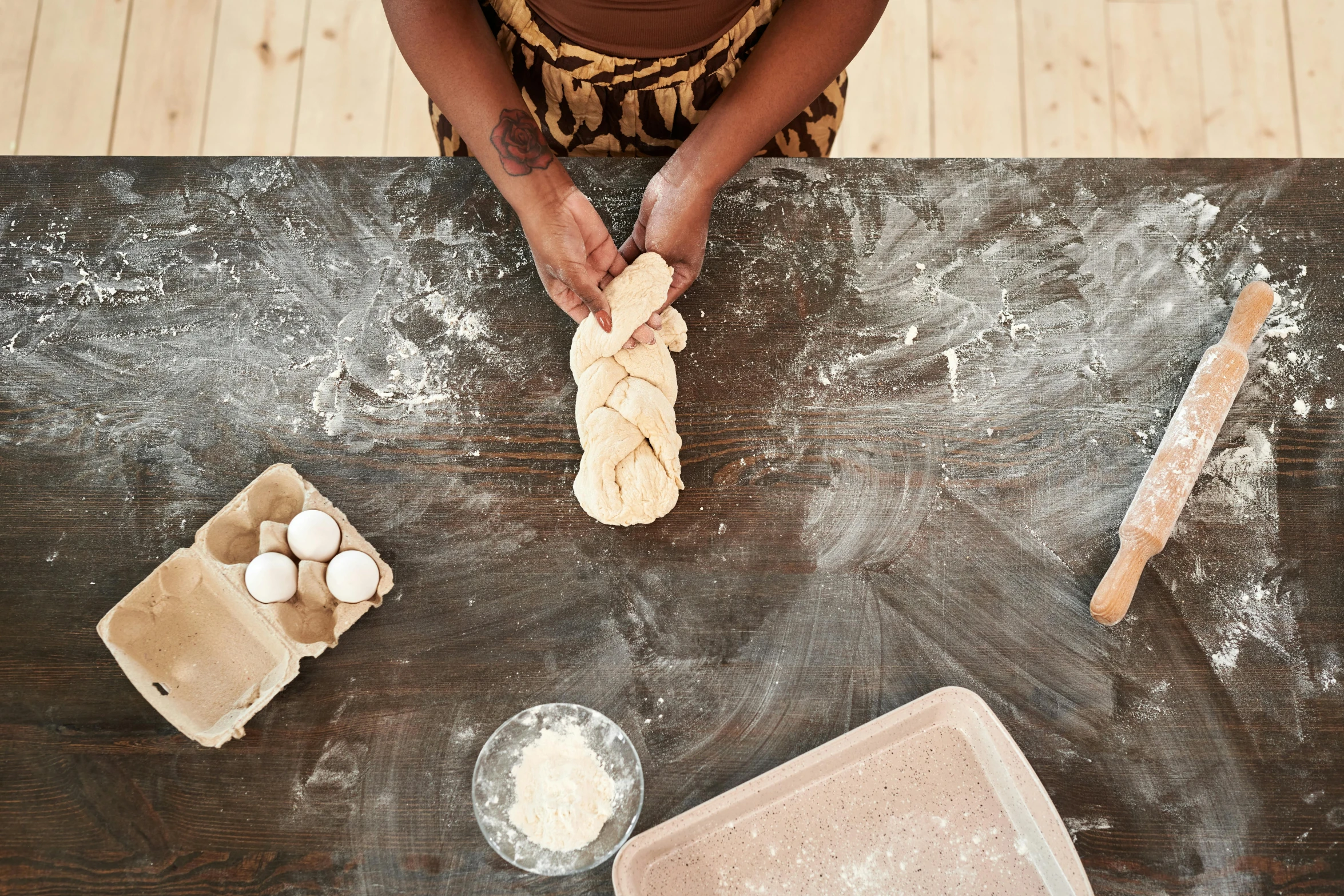 a woman kneads bread dough on a table, inspired by Sarah Lucas, unsplash, unmistakably kenyan, ignant, 5 years old, mixed materials