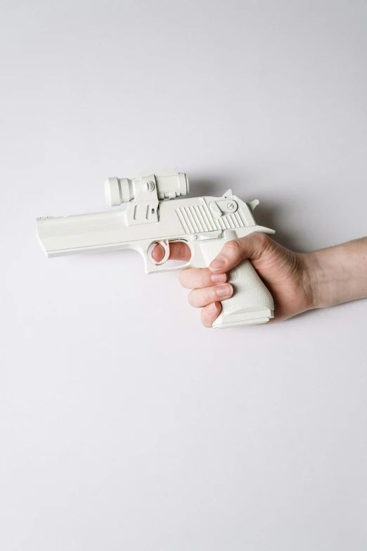 a person holding a toy gun in their hand, 3 d print, 1980s