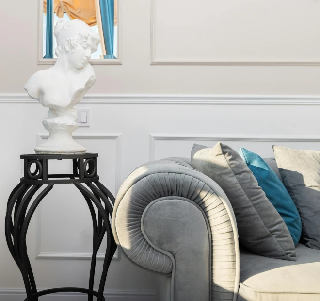 a living room filled with furniture and a statue, a marble sculpture, inspired by Jacques-Louis David, trending on cg society, neoclassicism, soft grey and blue natural light, middle close up composition, ashford black marble sculpture, smooth panelling