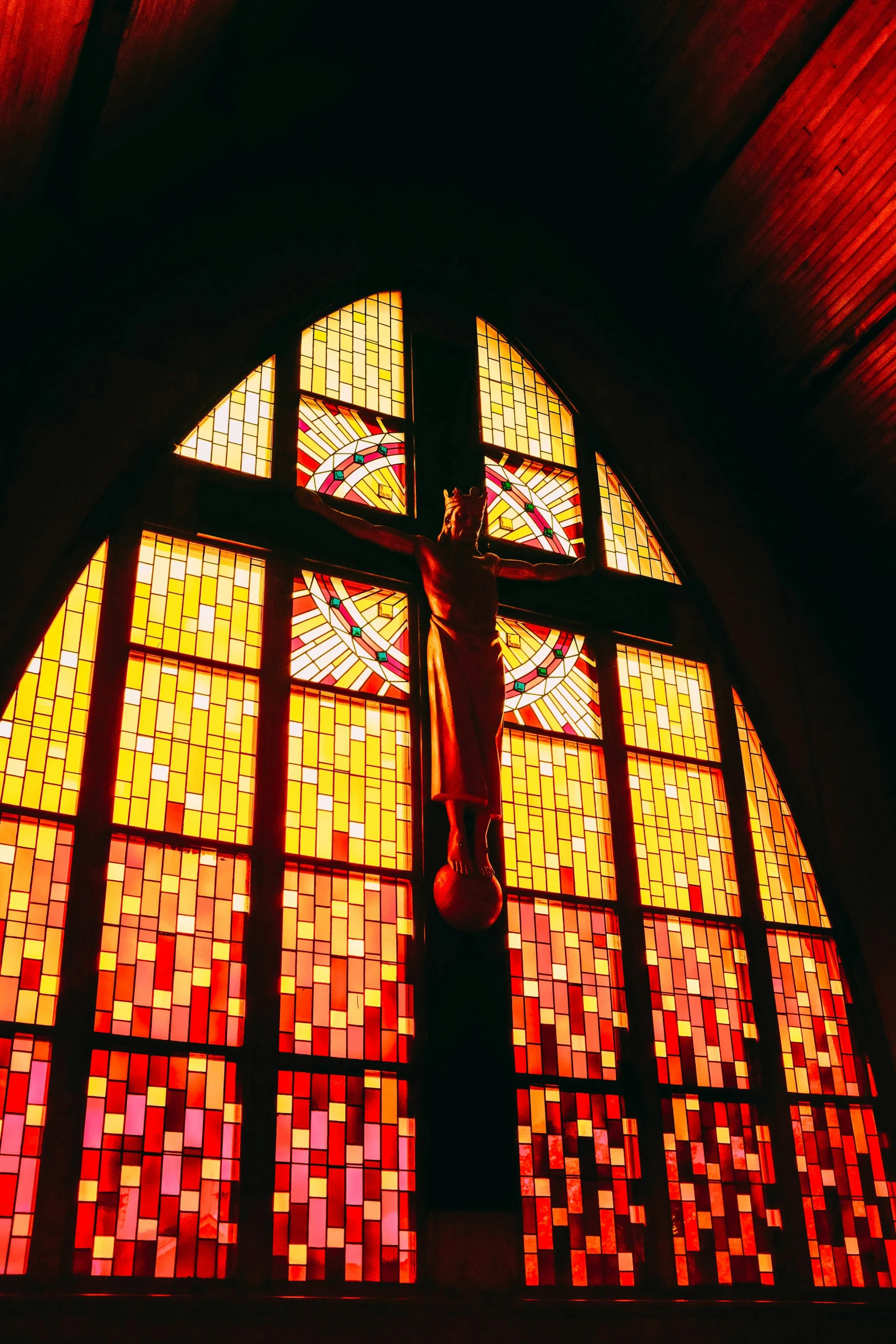 a cross in front of a stained glass window, orange and red lighting, 2000s, manila, multiple stories