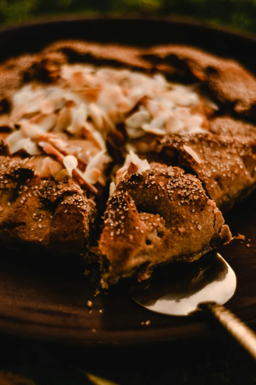 a pizza sitting on top of a brown plate, inspired by Jacopo Bellini, unsplash, hurufiyya, chocolate. rugged, close up details, thumbnail, brown bread with sliced salo