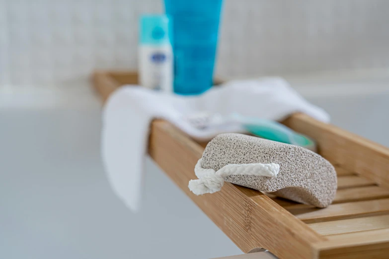 a bath room with a bath tub and a towel, by Julian Allen, unsplash, on a wooden tray, close up shot from the side, products shot, shot with sony alpha