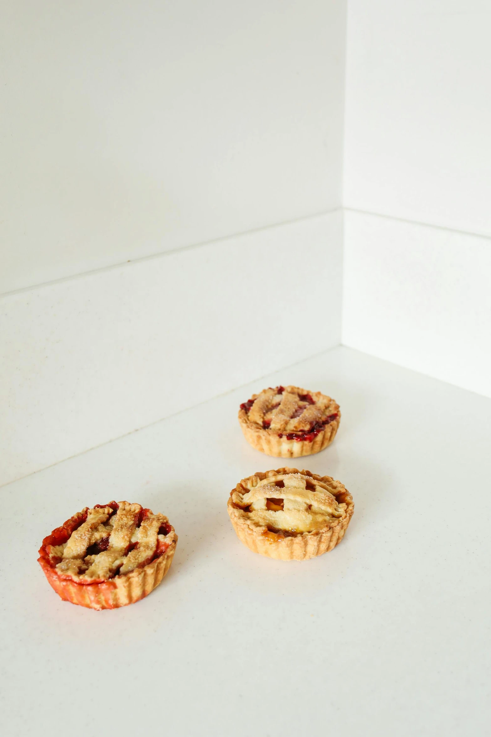 a couple of pies sitting on top of a white counter, product image, petite, in a row, thumbnail